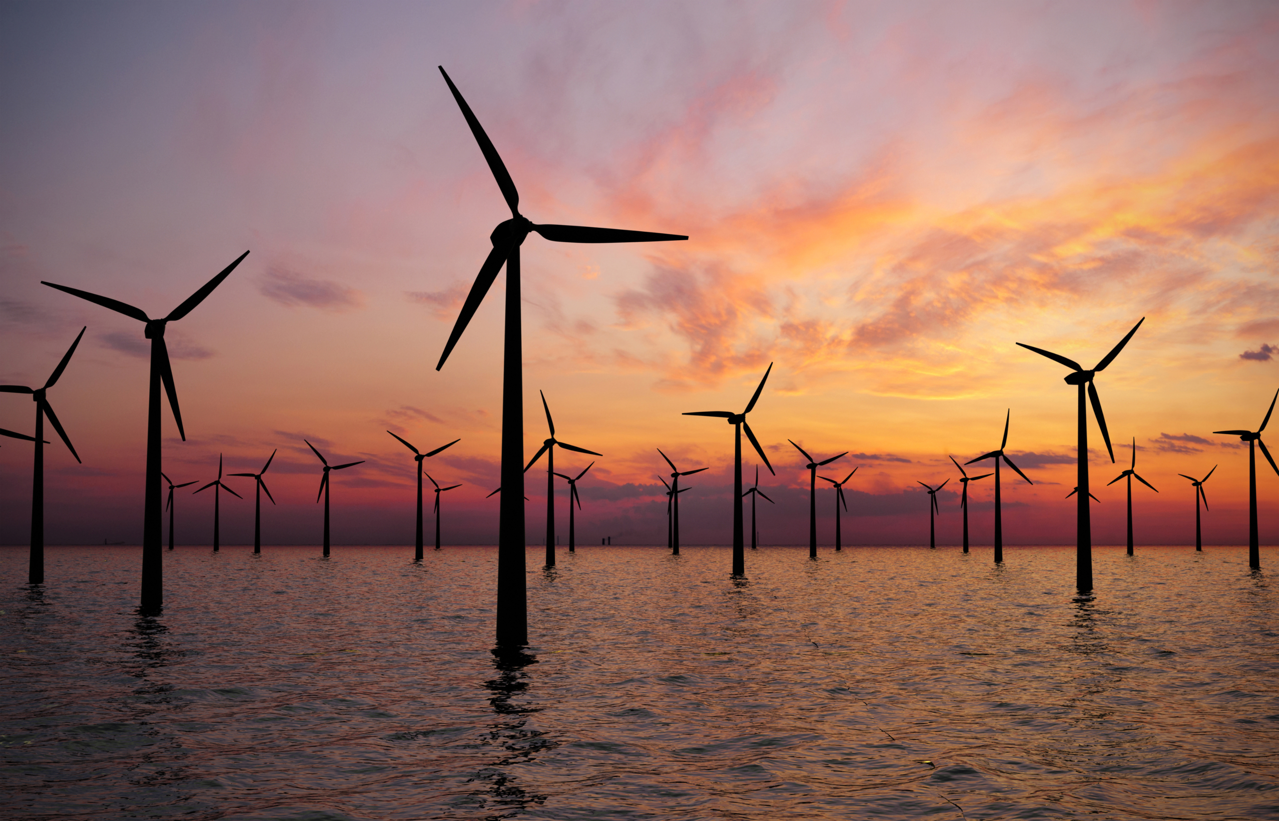 ESG Wind farm in the sea at sunset